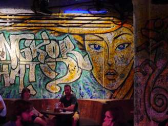 A vibrant urban art mural blending with a cozy, colorful interior design setting.