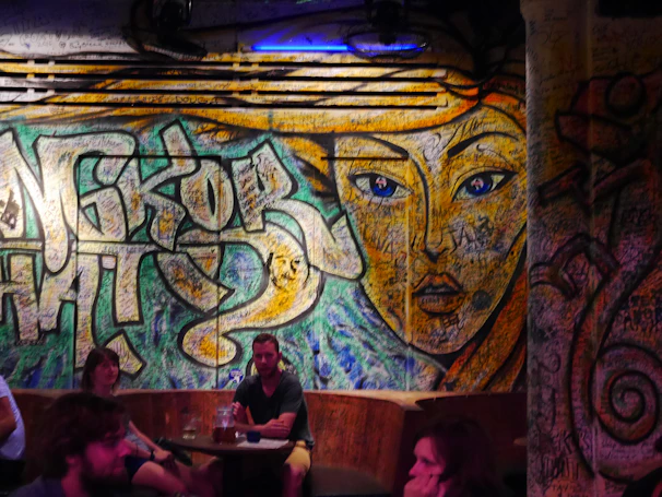 A vibrant urban art mural blending with a cozy, colorful interior design setting.