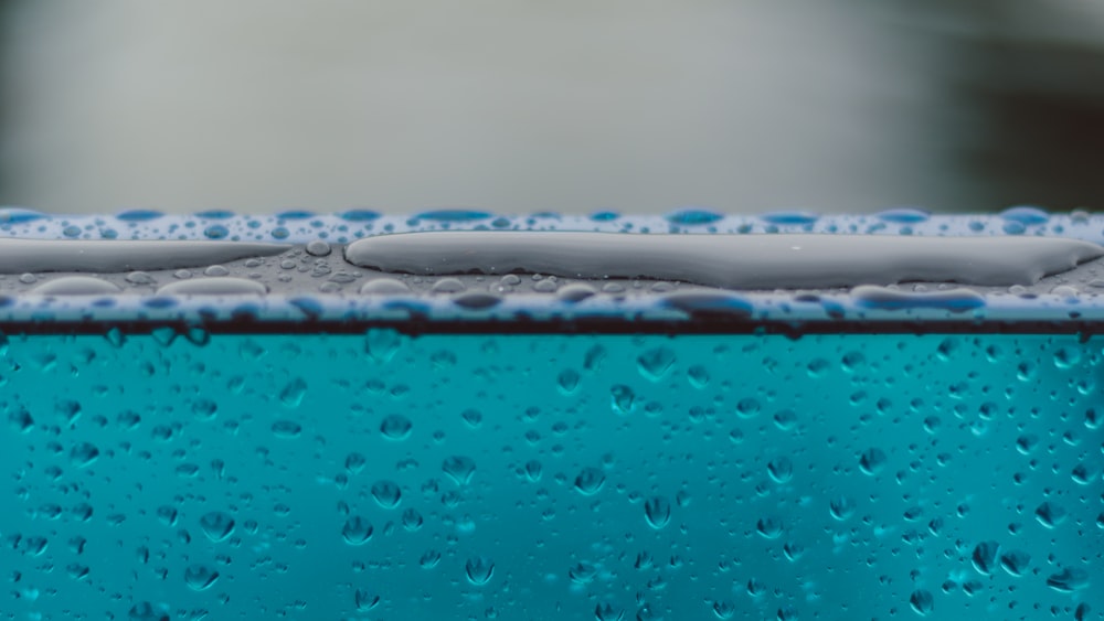 macro photography of water drops on glass surface