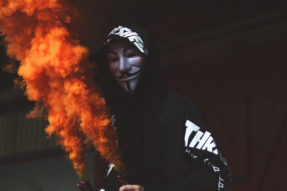 person wearing guy fawkes mask