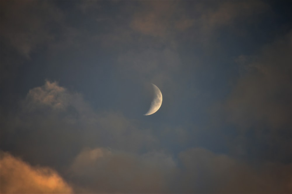 worm's eye view photography of cresent moon and blue skies