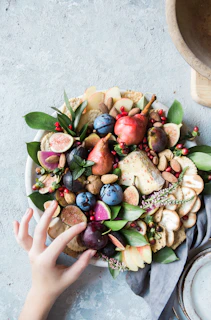 Fresh, vibrant almonds and raisins arranged artfully on a wooden platter