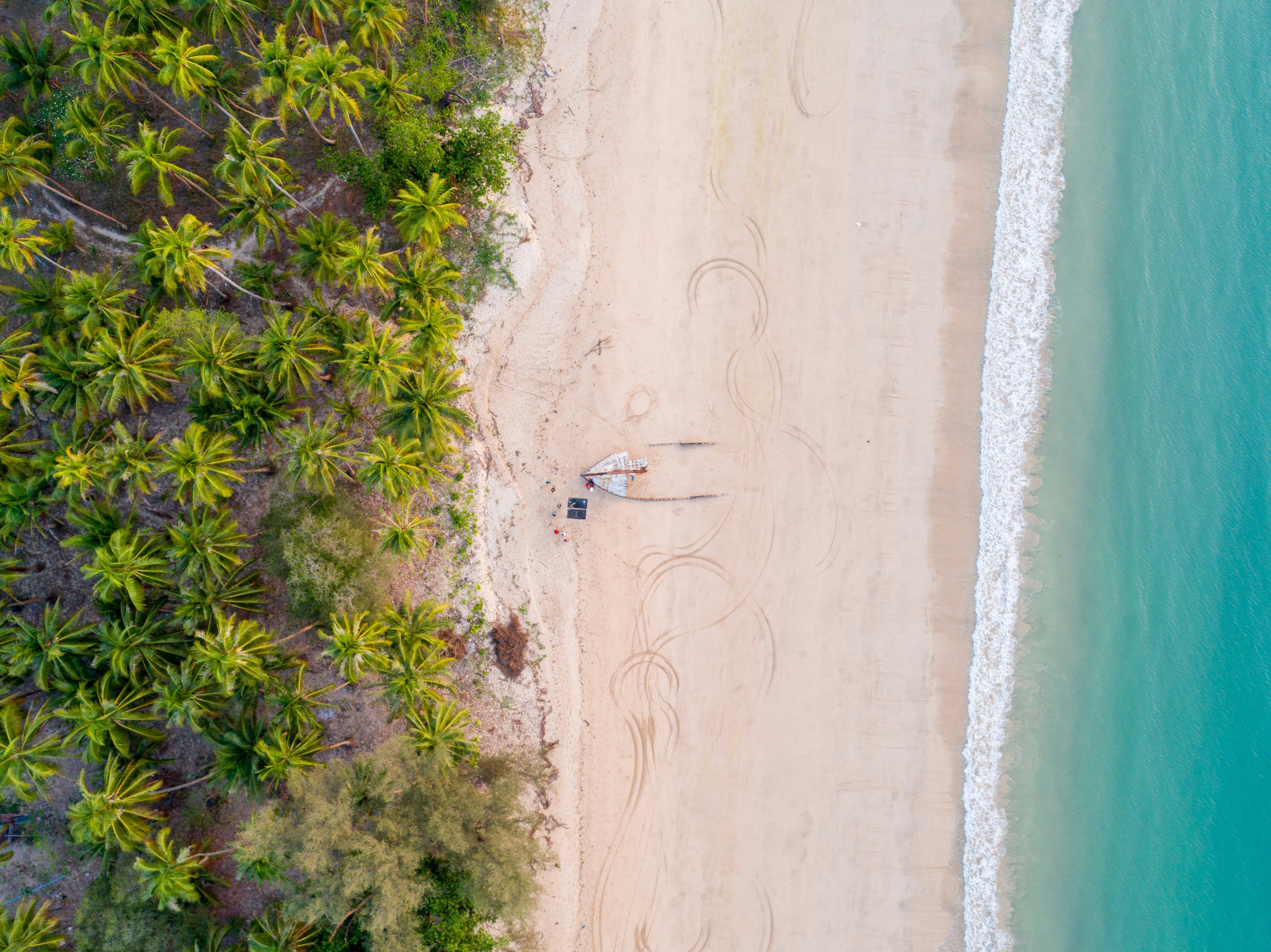 aerial photography of seashore, Locals on this island south of the Ngapali beach claim this ship washed on these shores still burning away and capsized. I love the calm nature of this photo and the layers to it