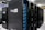 Several server racks with the logo 'imgIX' are neatly arranged in a data center. The racks are equipped with blue and yellow cable management, ensuring proper organization of the cables inside. The room is well-lit with overhead lighting and has a modern, clean appearance.