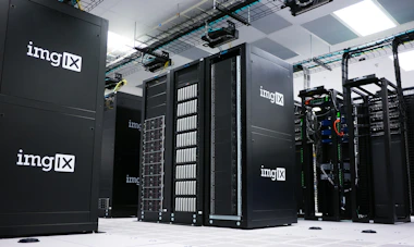 Network infrastructure with servers and cables organized in a data center room.