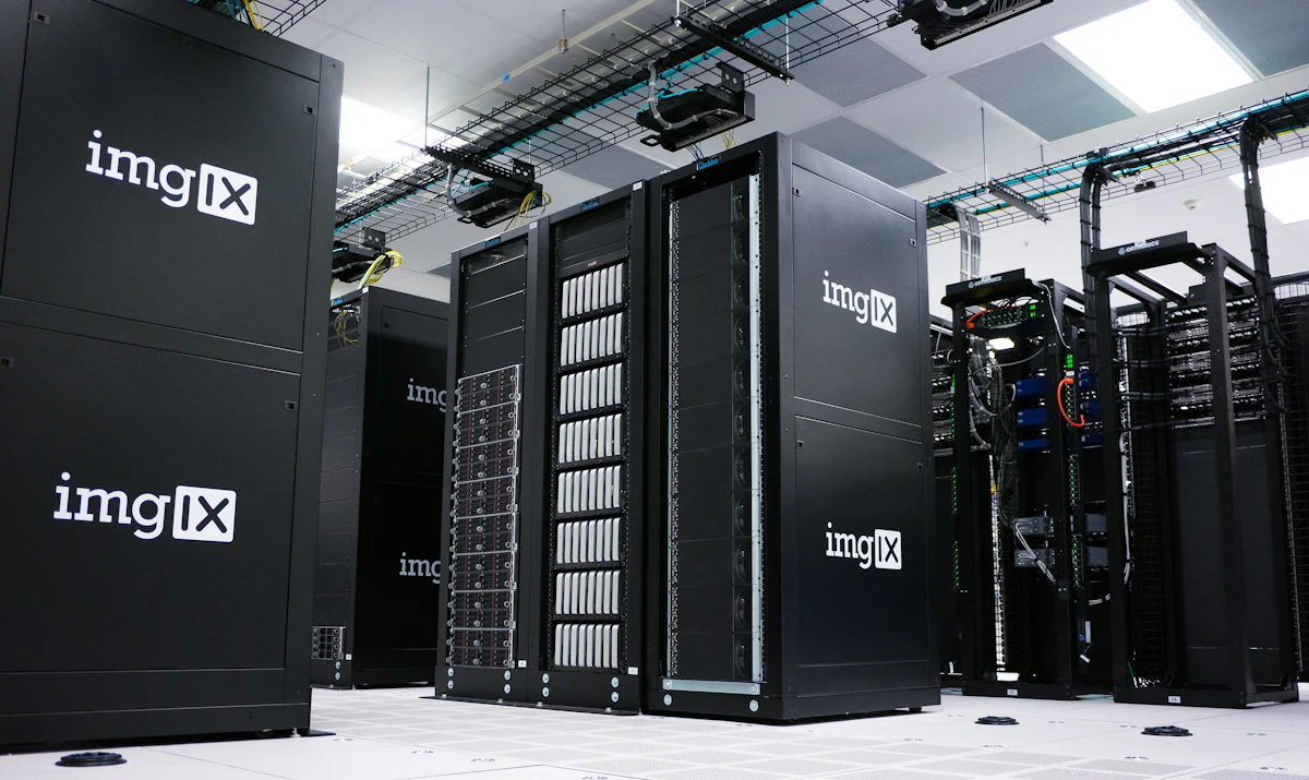 Server hardware racked in a white equipment room