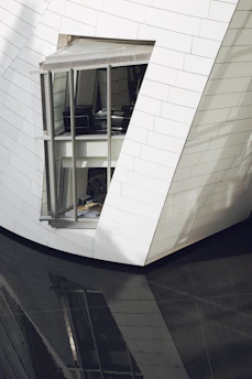 The exterior of a sleek law firm building featuring slate gray and crisp white architectural details.