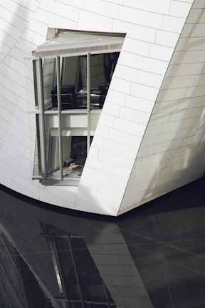 Technical consultant reviewing architectural plans in a sleek, contemporary office.