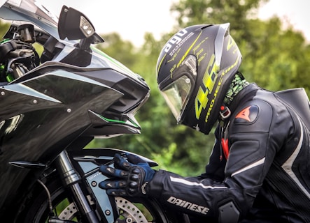person wearing helmet while holding motorcycle