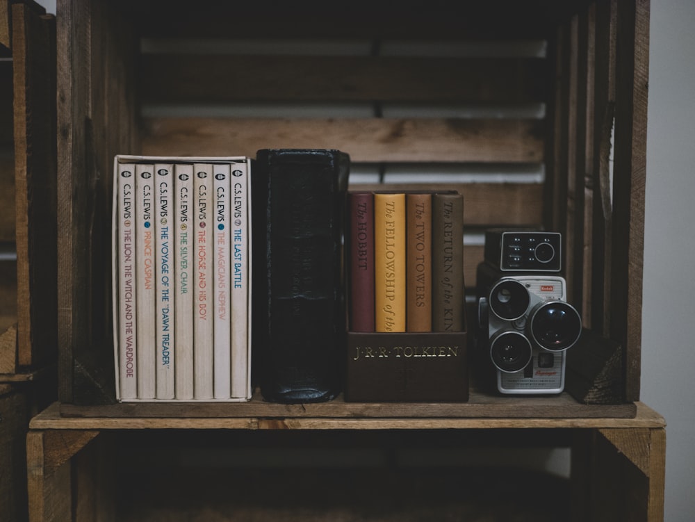 camera on brown wooden shelf