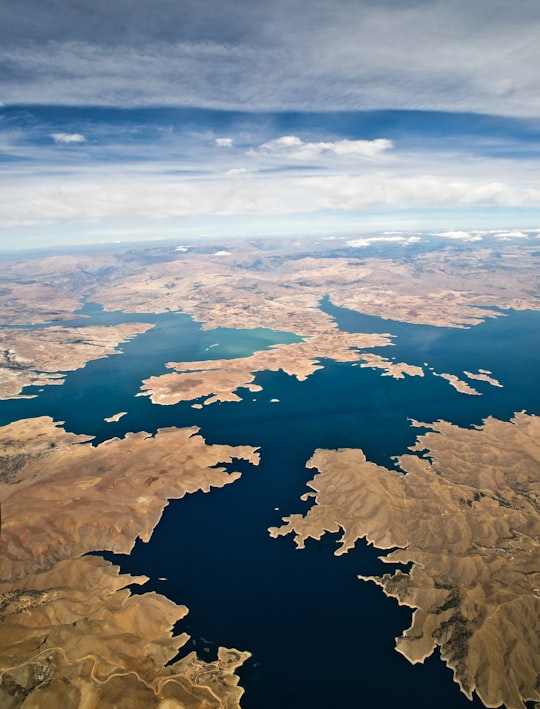 aerial shot of body of water surrounded by land in Keban Dam Turkey