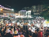 View of Taipei night market bustling with people and colorful lights.