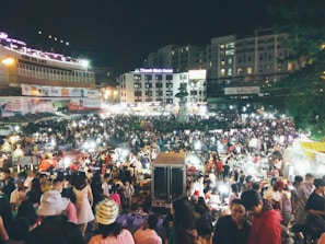 A bustling night market with colorful lights and people immersed in urban culture