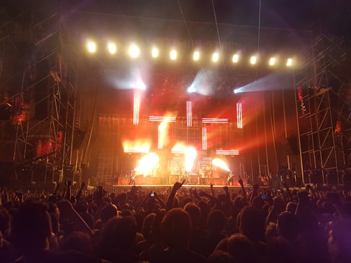 A panoramic view of a large crowd enjoying a concert with expertly installed sound and lighting.