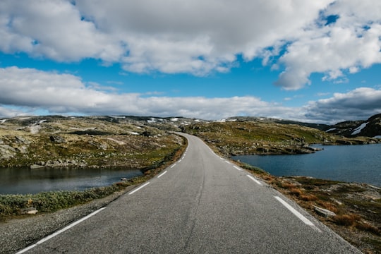 gray asphalt road under blue sky during daytime in Lærdalsøyri Norway