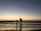 silhouette of man and kid on seashore