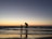 silhouette of man and kid on seashore