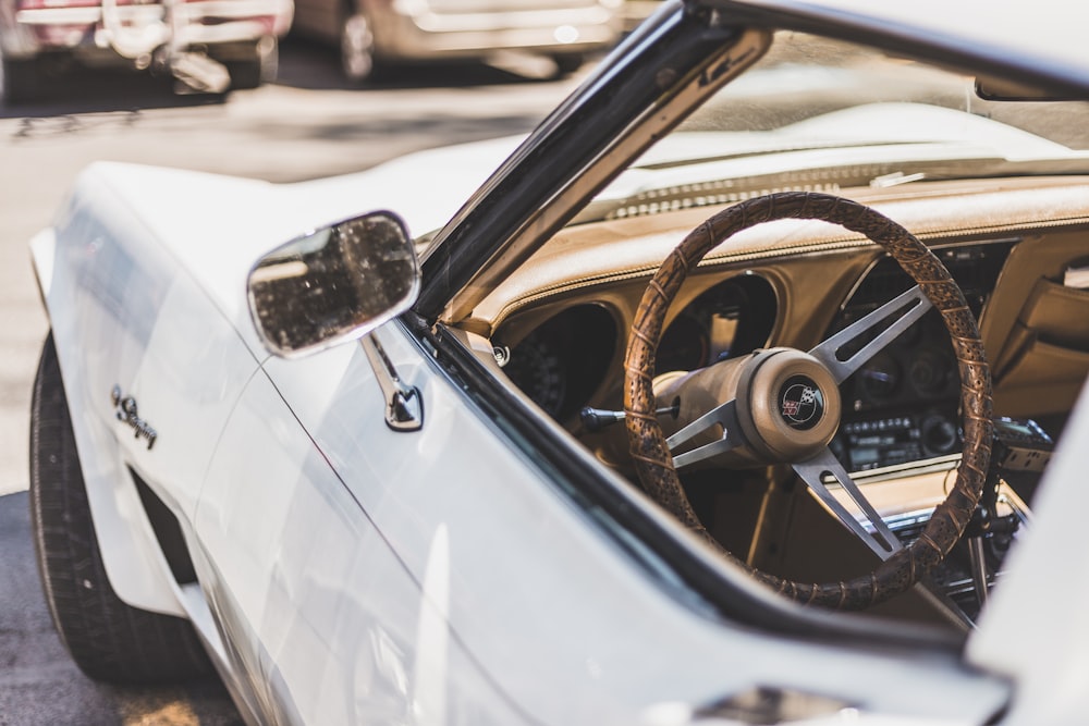 white vehicle parks on road during daytime