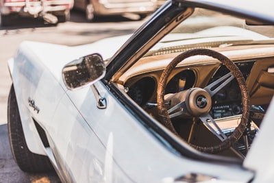 white vehicle parks on road during daytime luxury google meet background