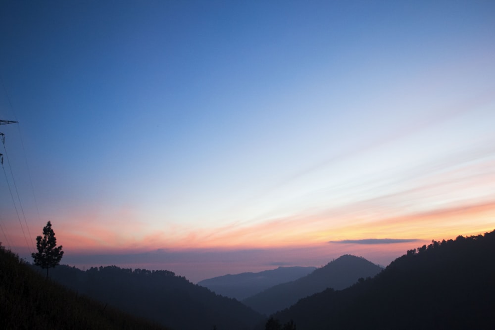 silhouette of mountains under blue sky