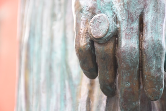 Close-up of a bronze sculpture being carefully finished after casting, highlighting fine details and craftsmanship.