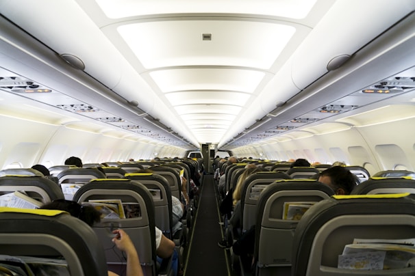 A cozy airplane cabin with passengers comfortably settled for their journey.