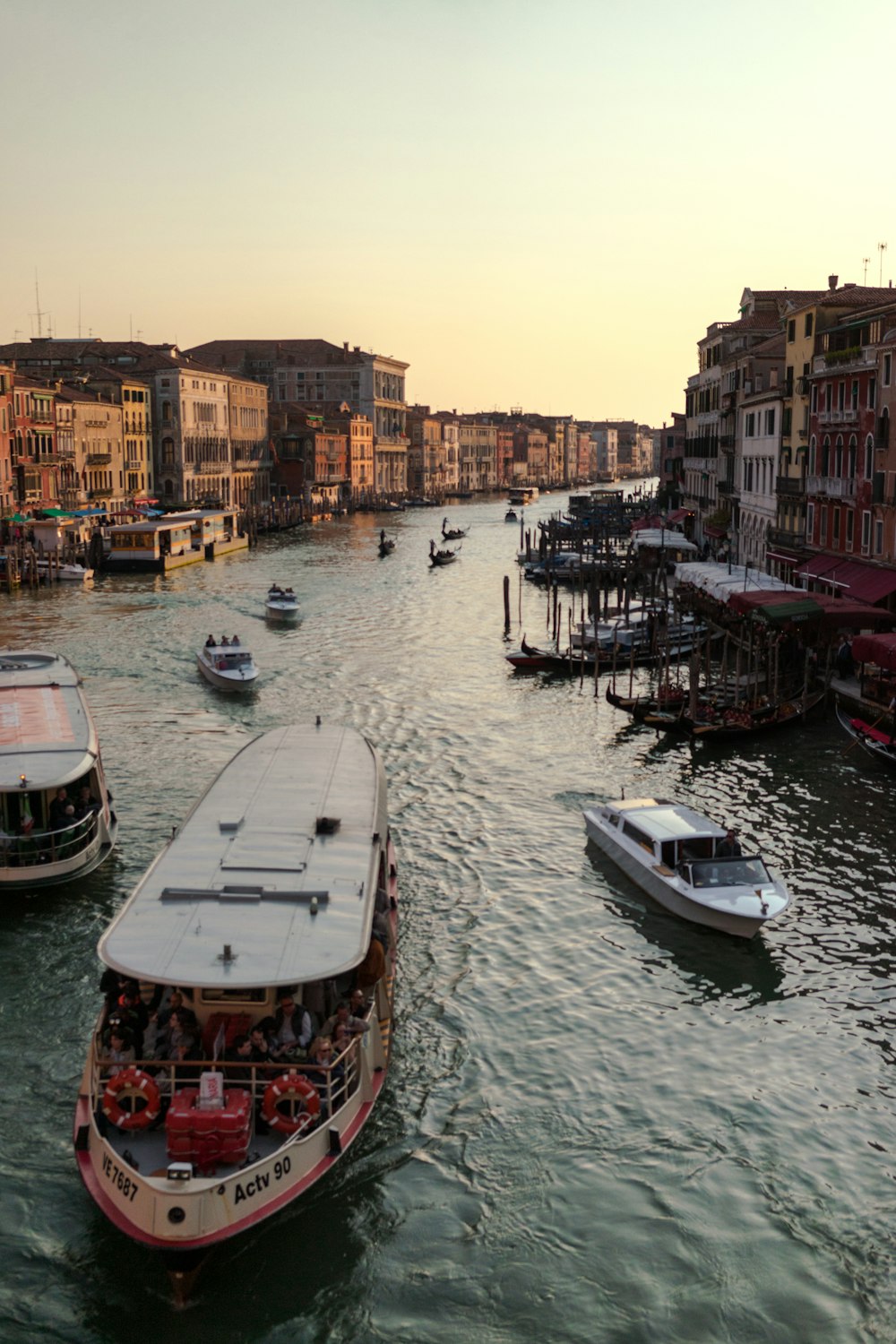 white boat on body of water near buildings during daytime