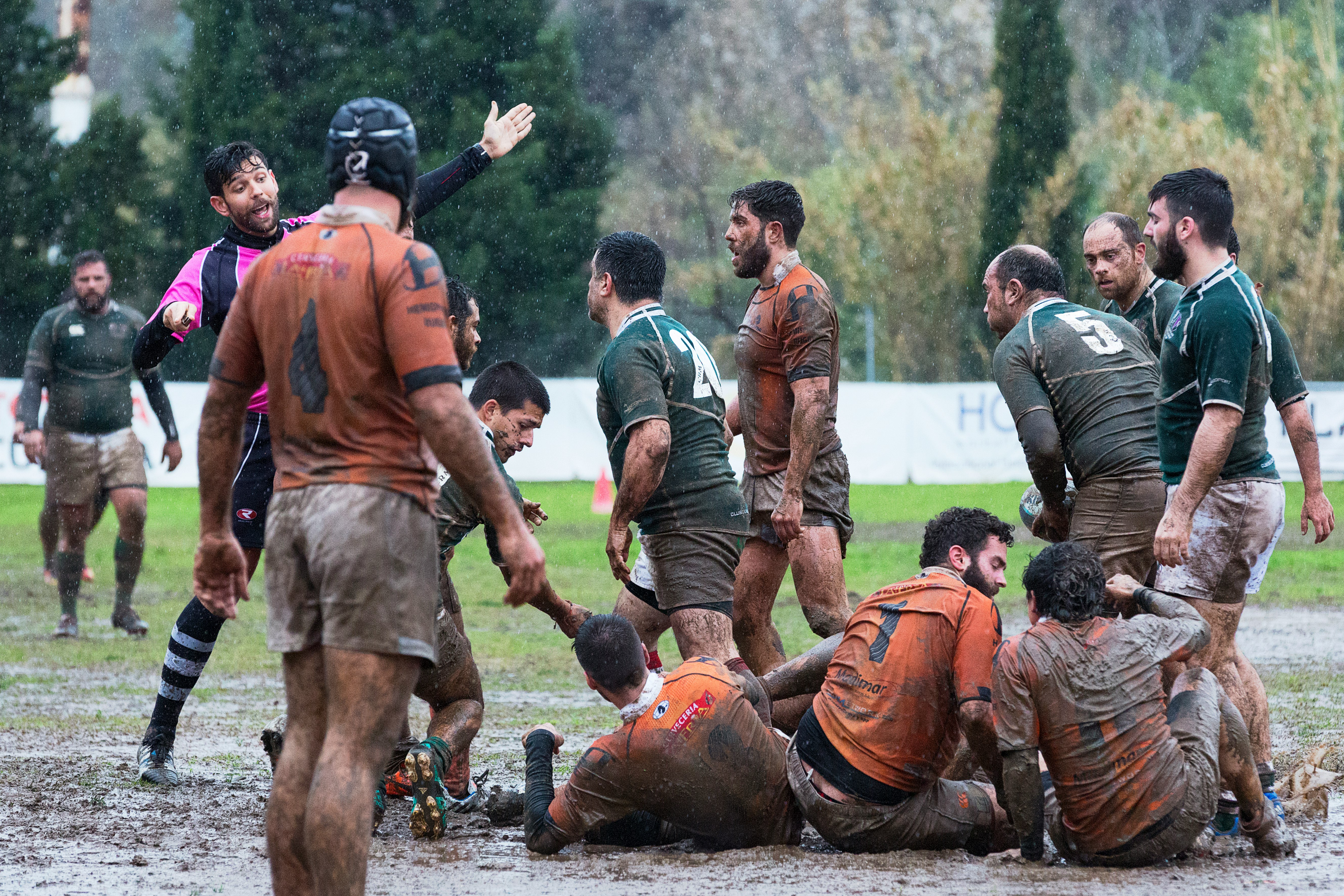 people playing soccer at mud