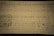 A sheet of music manuscript with printed musical notes and handwritten annotations. The page appears aged, with visible yellowing and ink smudges. A section on the left contains a grid filled with musical notation, while the main body of the page shows lines of musical notes and lyrics.