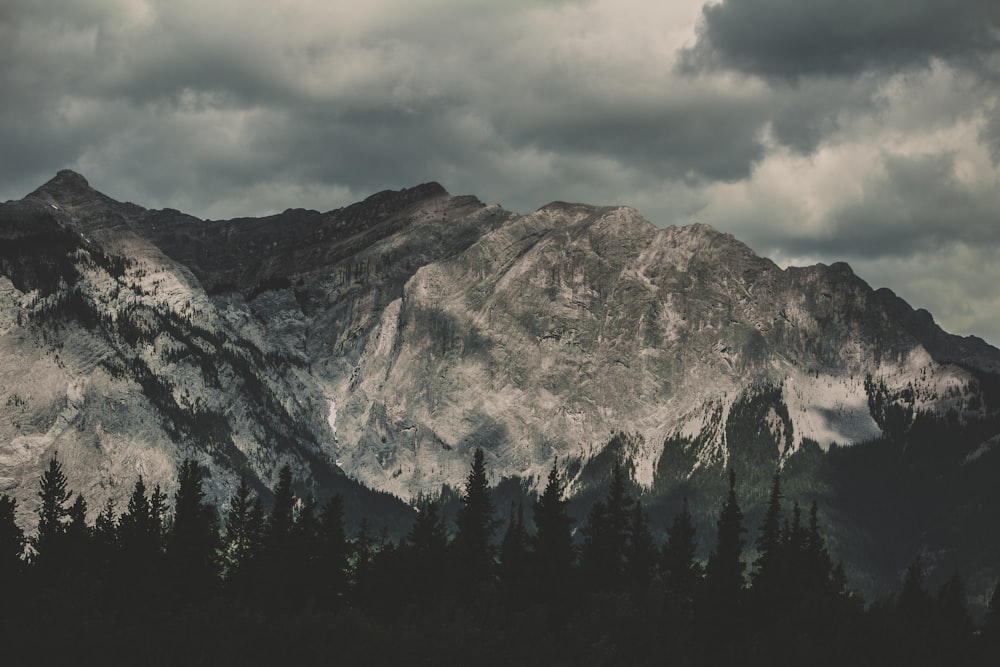 gray mountain under cloudy sky