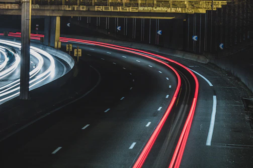 long exposure shot of cars on a road at night