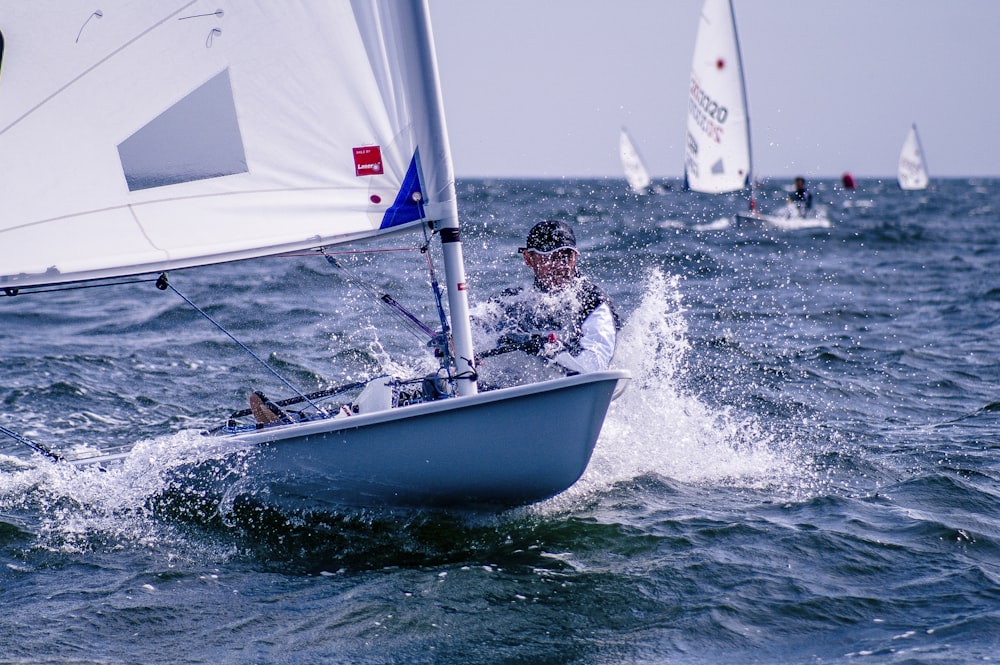 man riding sailboat