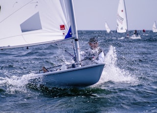 man riding sailboat