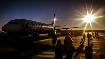 silhouette of people near plane