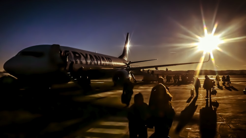 silhouette of people near plane