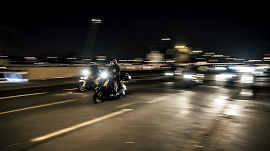 A dynamic street racing scene featuring sleek cars and motorbikes speeding down a winding road.