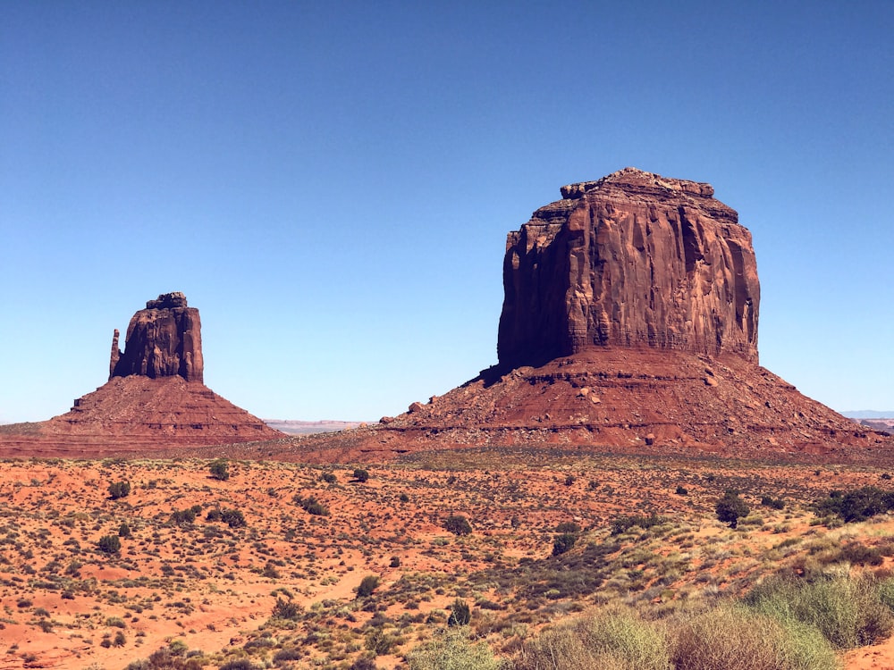 brown rock formation under blue sky