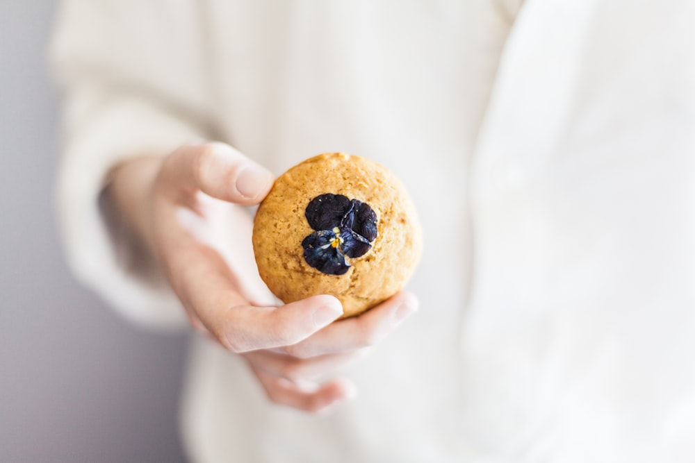 person holding brown cookie