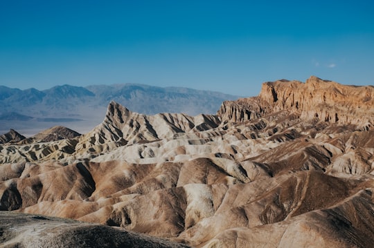 brown loess under clear blue sky in Death Valley National Park, Zabriskie Point United States