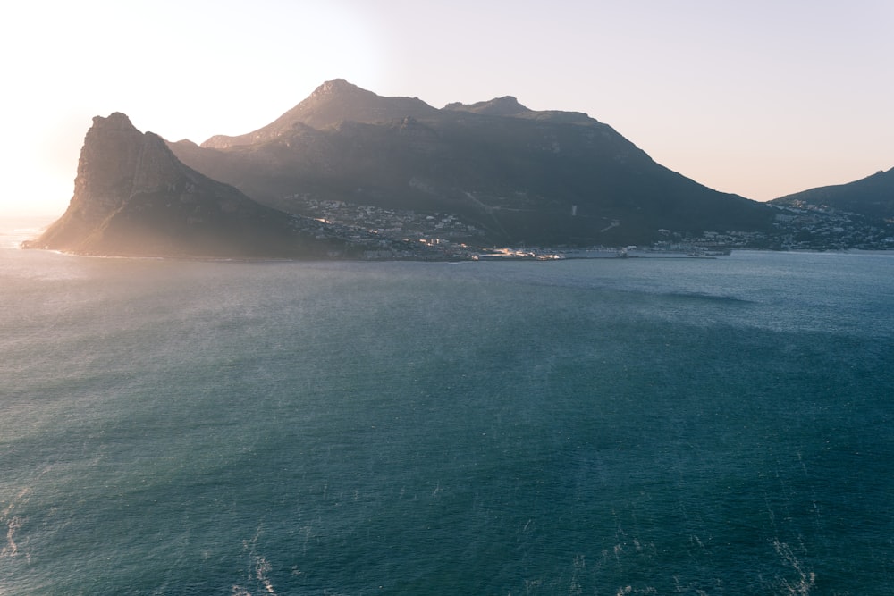 photo of mountain near body of water