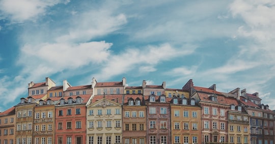 photo of brown building during day time in Old Town Market Square Poland