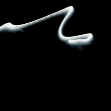 Abstract dark shape flowing with smooth motion lines representing animation.