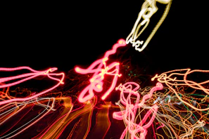 A dynamic 3D animation of swirling geometric shapes in vibrant colors