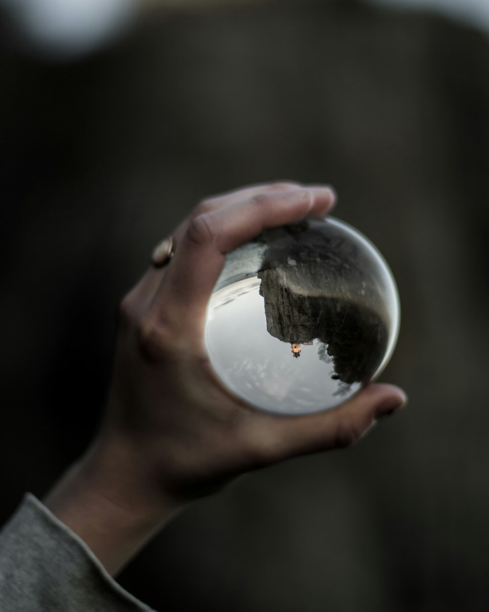 person holding clear glass water globe