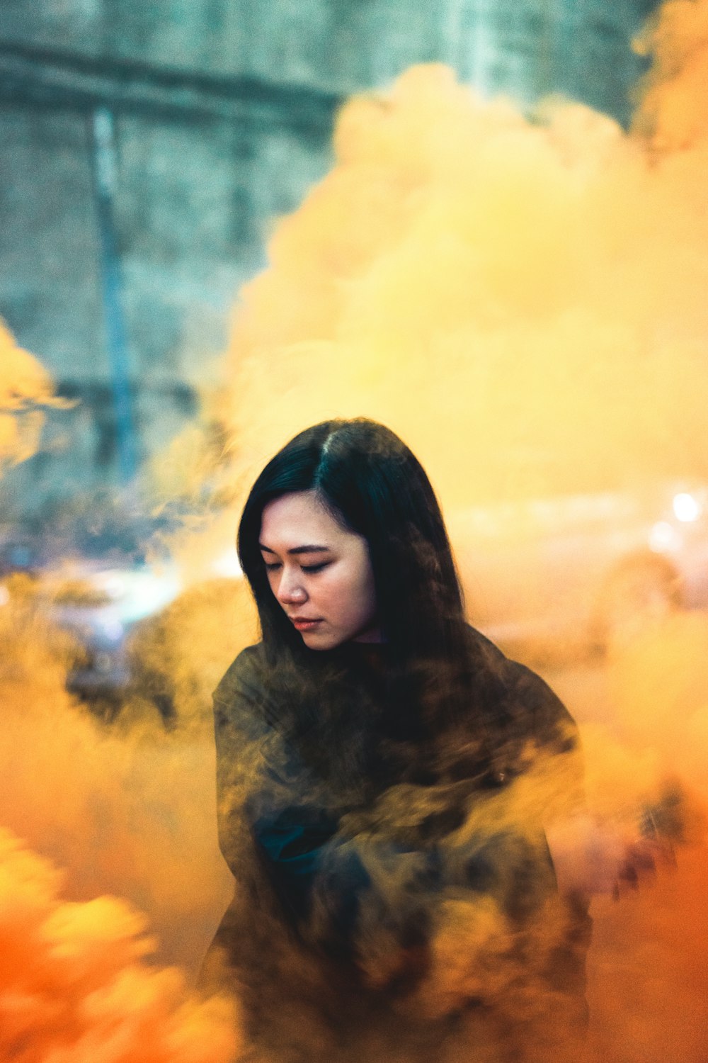 woman surrounded by orange smoke