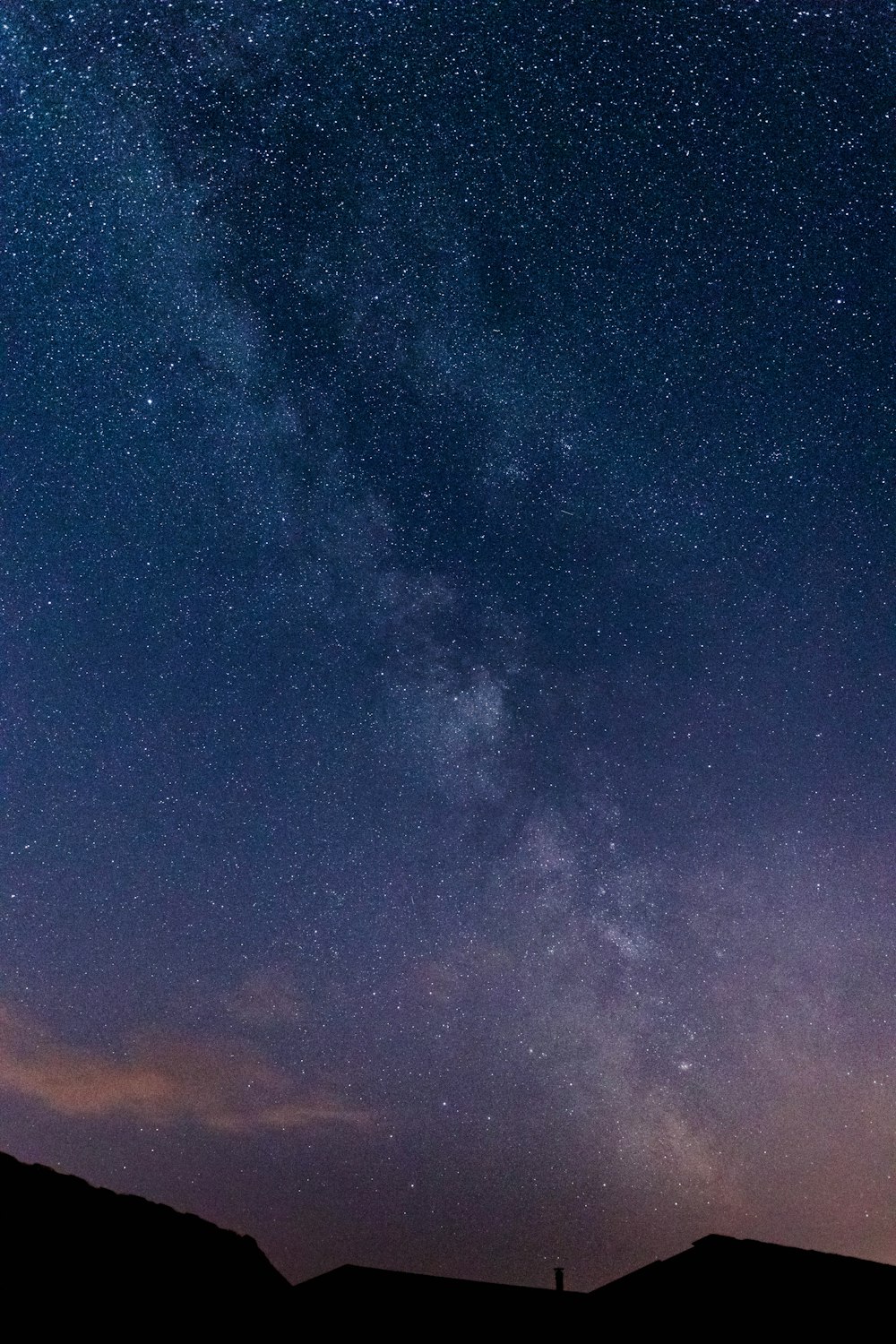 silhouette of mountain and view of stars