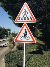 Traffic signs and a person reading a legal pamphlet about traffic rules.