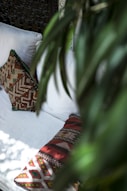 red and brown throw pillow on white bed