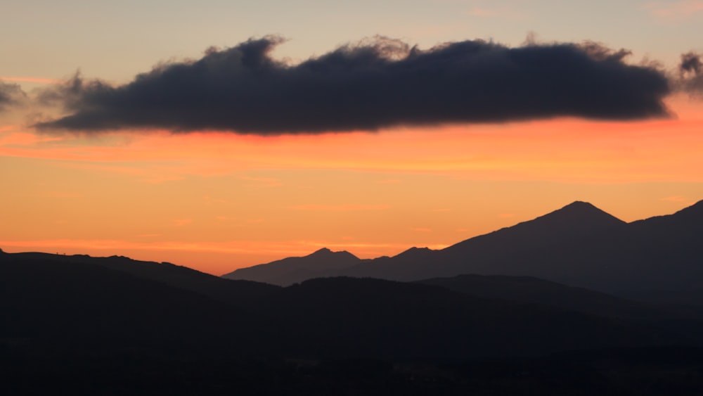 silhouette photo of mountain at golden hour