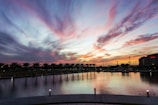 Sunset over the Panama City skyline with colorful clouds reflecting on the water.
